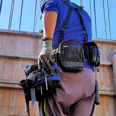 construction worker wearing our Niche tool belt with suspenders and pouches while working, breathable and comfortable suspender and provide even weight distribution.
